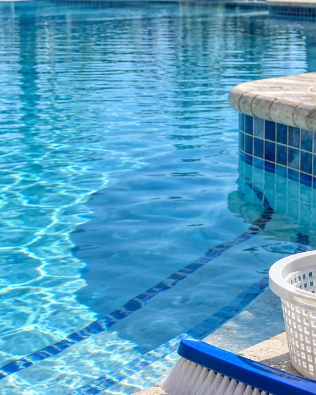 Close view of pool brush and clean tile at a commercial pool